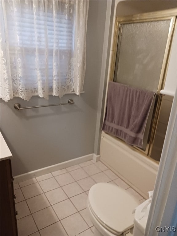 full bathroom with tile patterned flooring, vanity, toilet, and bath / shower combo with glass door