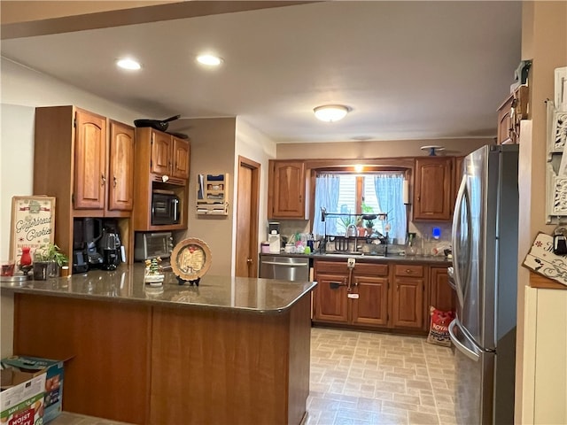 kitchen featuring kitchen peninsula, sink, and appliances with stainless steel finishes