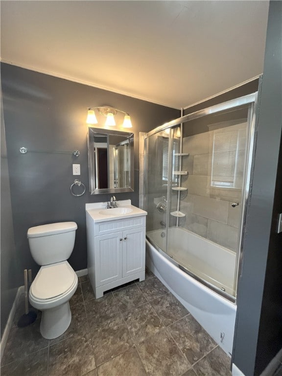 full bathroom with combined bath / shower with glass door, vanity, and toilet