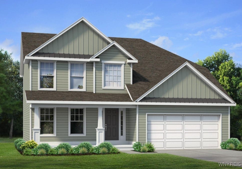 view of front of property with a garage and a front lawn