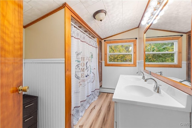 bathroom with wood walls, lofted ceiling, ornamental molding, baseboard heating, and wood-type flooring