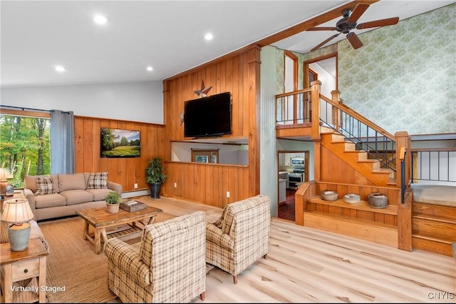 living room with ceiling fan, lofted ceiling, a baseboard radiator, and light hardwood / wood-style flooring