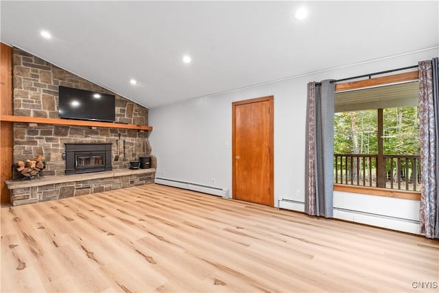 unfurnished living room with vaulted ceiling, light wood-type flooring, and a baseboard heating unit