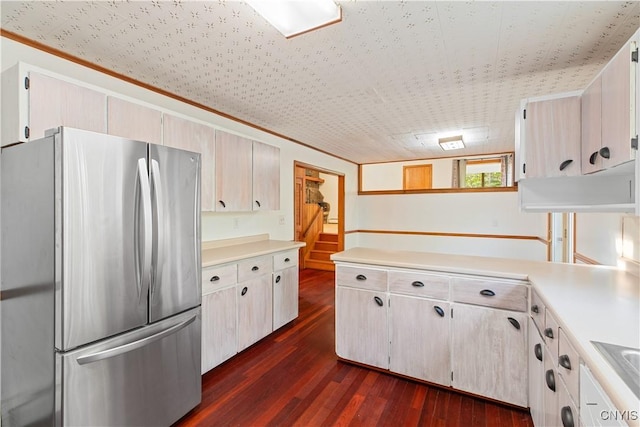 kitchen with sink, stainless steel refrigerator, dark wood-type flooring, and crown molding