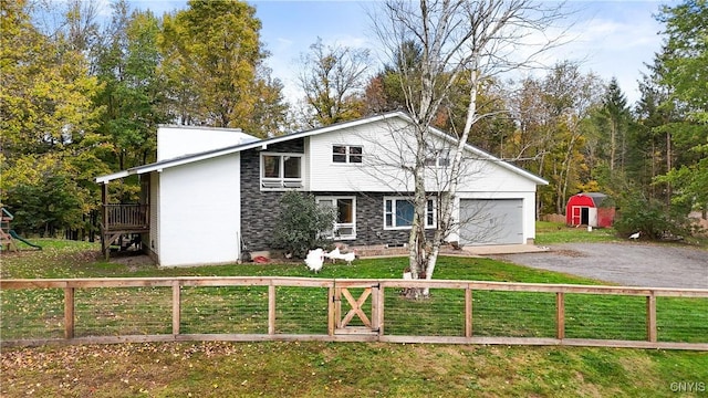 view of front of home featuring a front yard and a storage unit