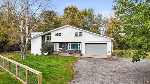 view of front of property featuring a garage and a front yard