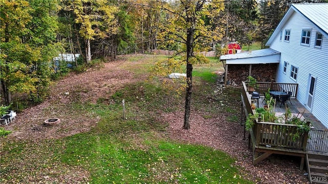 view of yard featuring a fire pit and a patio