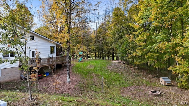 view of yard with a fire pit and a deck