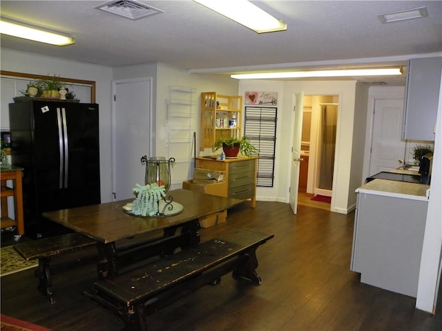 dining area featuring dark wood-type flooring