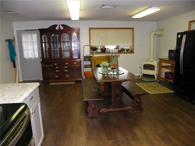 dining room with dark hardwood / wood-style flooring and heating unit