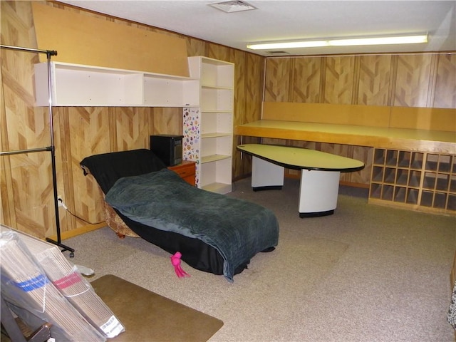 bedroom featuring carpet flooring and wooden walls