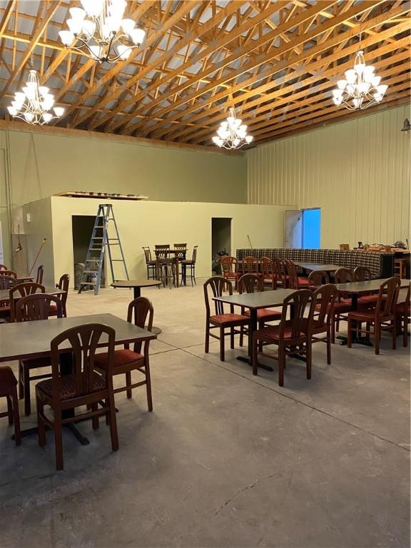 dining space with a notable chandelier and concrete flooring