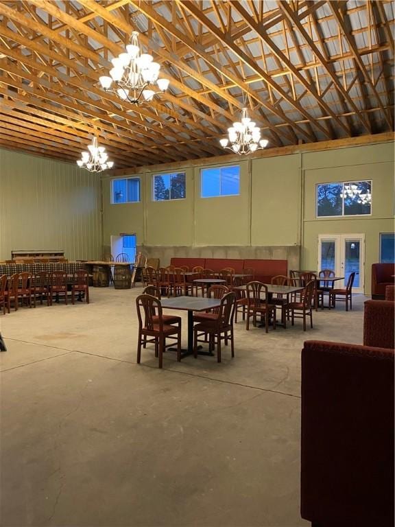 dining room with concrete floors and an inviting chandelier