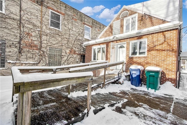 view of snow covered back of property