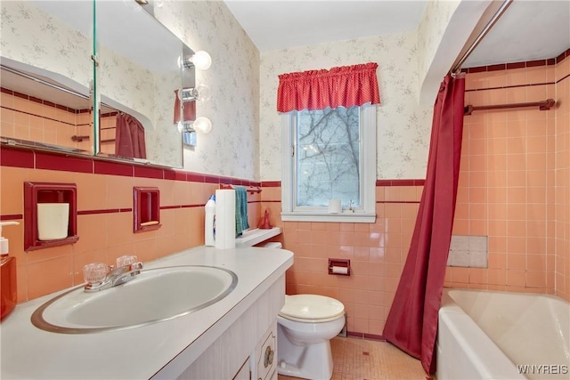 full bathroom with vanity, tile patterned flooring, toilet, shower / bathtub combination with curtain, and tile walls