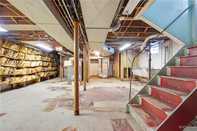 basement featuring heating unit and water heater