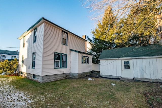 back of house with a lawn