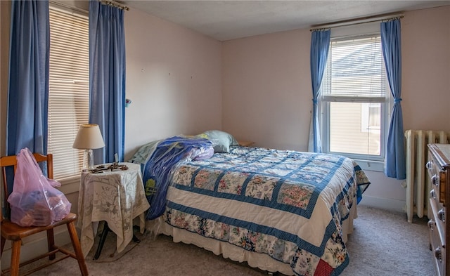 carpeted bedroom with radiator heating unit