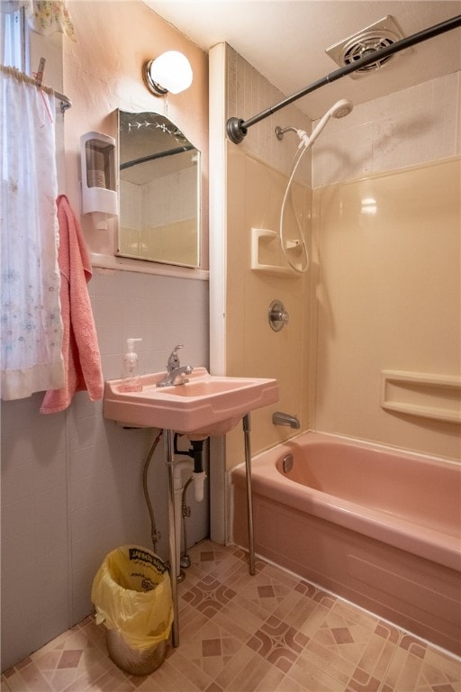 bathroom with bathing tub / shower combination and sink