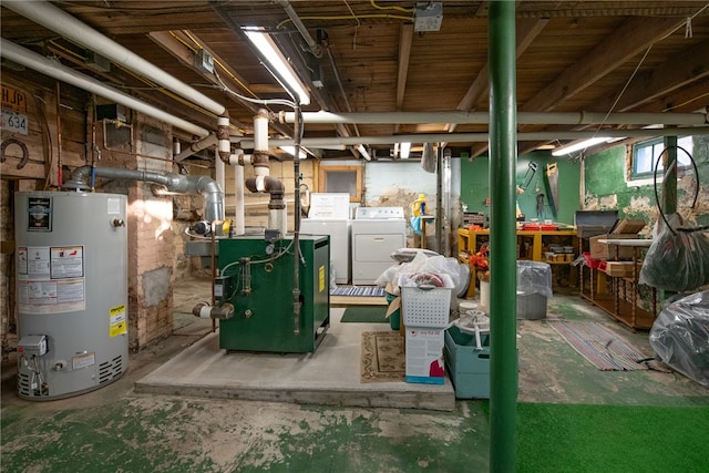 basement featuring gas water heater and washing machine and dryer