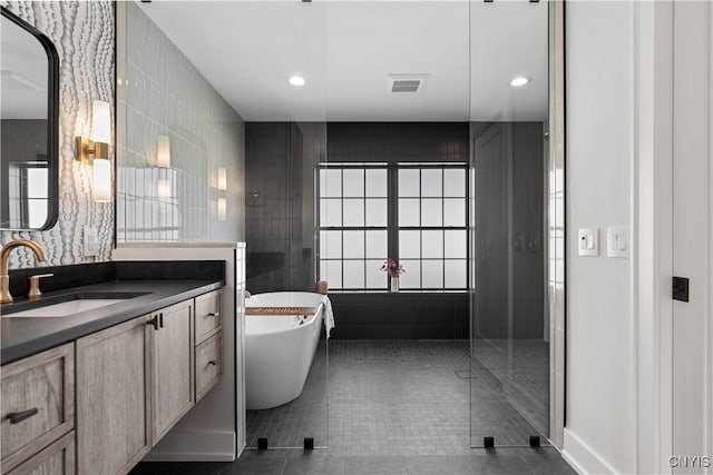 bathroom with tile patterned flooring, vanity, and separate shower and tub