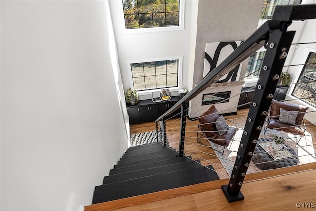 stairs featuring hardwood / wood-style flooring and a wealth of natural light