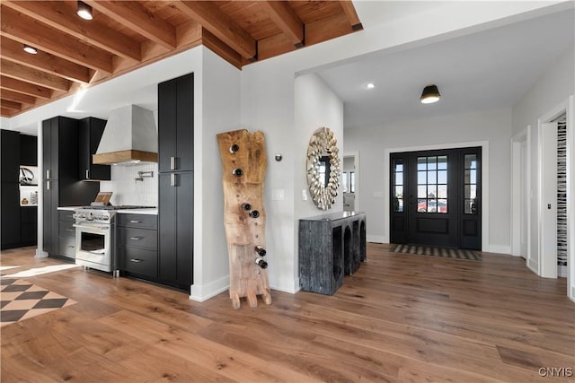 entrance foyer featuring beam ceiling, light hardwood / wood-style flooring, and wood ceiling