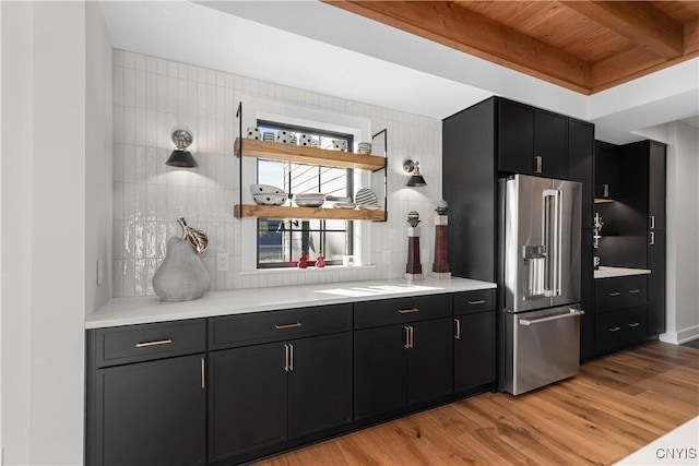 kitchen with wooden ceiling, high end refrigerator, beamed ceiling, light hardwood / wood-style floors, and decorative backsplash