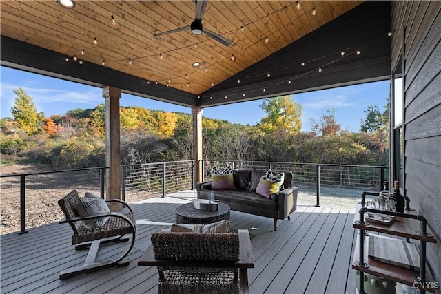 wooden deck featuring outdoor lounge area and ceiling fan