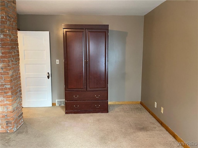 unfurnished bedroom featuring light carpet