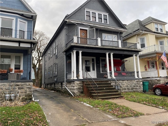 view of front of house with covered porch and a balcony