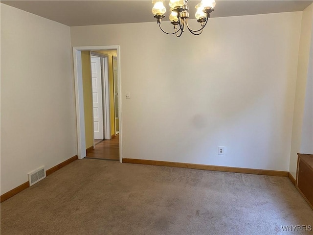 unfurnished room featuring carpet floors and a notable chandelier