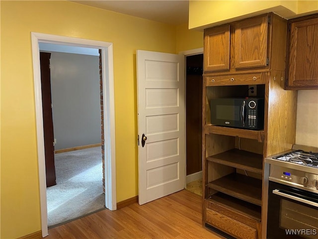 kitchen with light hardwood / wood-style floors and oven