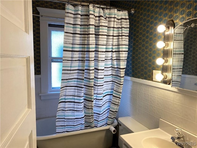 full bathroom featuring shower / bath combo with shower curtain, vanity, tile walls, and toilet