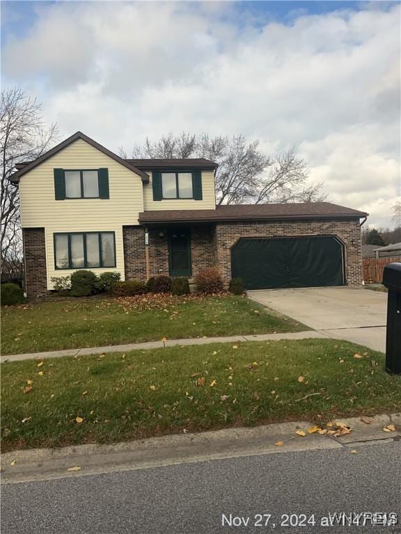 view of front property featuring a garage and a front lawn