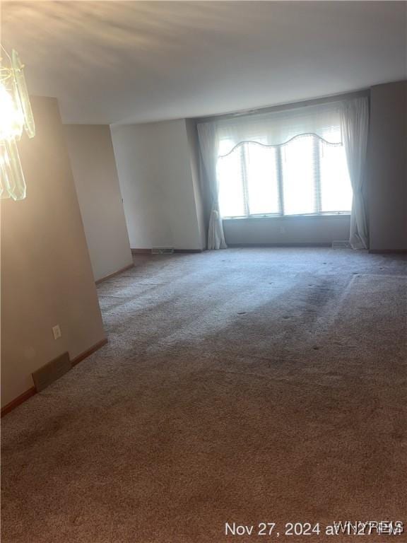 unfurnished room with carpet floors