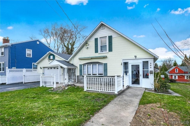 bungalow featuring a garage and a front yard