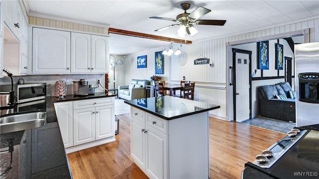 kitchen featuring white cabinetry, ornamental molding, and light hardwood / wood-style flooring