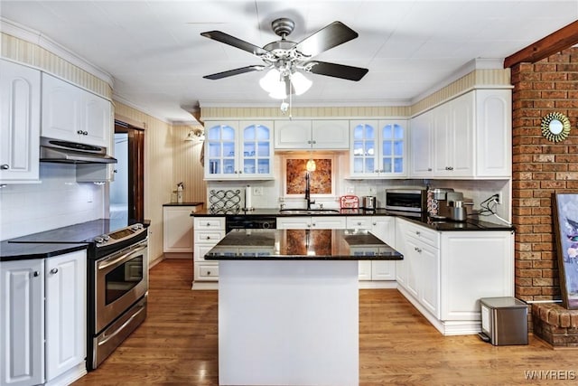 kitchen with a kitchen island, white cabinetry, sink, stainless steel range with electric stovetop, and light wood-type flooring