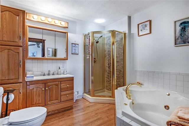 full bathroom with tasteful backsplash, a textured ceiling, vanity, independent shower and bath, and hardwood / wood-style flooring