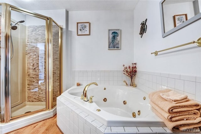 bathroom featuring plus walk in shower and wood-type flooring