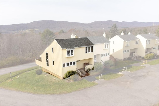 birds eye view of property with a mountain view