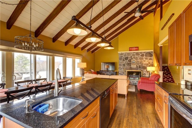 kitchen featuring sink, high vaulted ceiling, pendant lighting, and black dishwasher