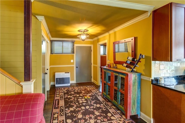 hallway featuring dark hardwood / wood-style flooring, ornamental molding, and heating unit