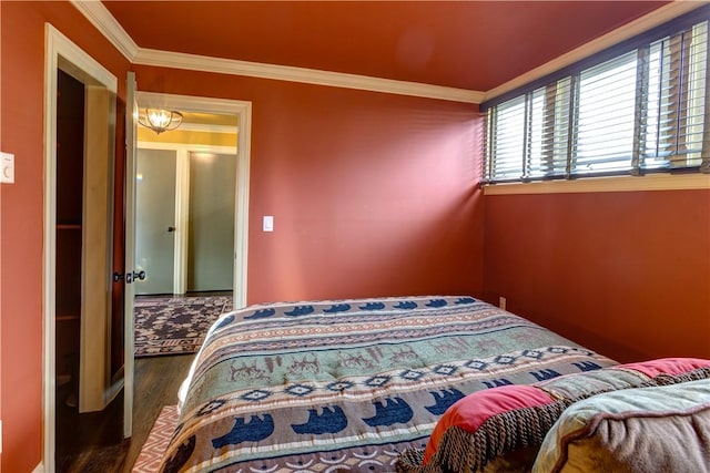 bedroom with dark wood-type flooring and ornamental molding