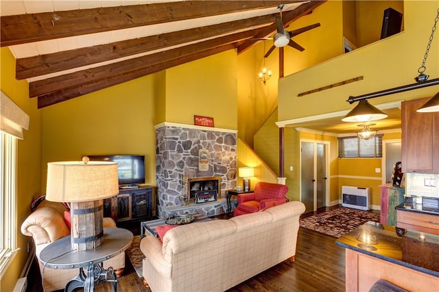 living room with beam ceiling, dark wood-type flooring, a stone fireplace, a baseboard heating unit, and heating unit