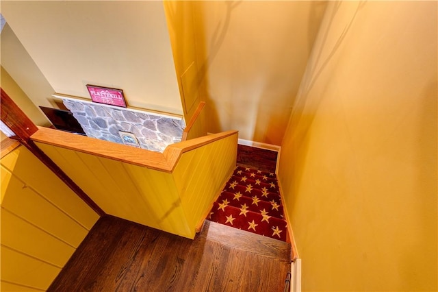 stairs featuring hardwood / wood-style floors