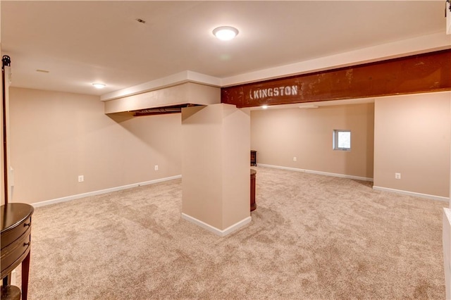 basement featuring light colored carpet