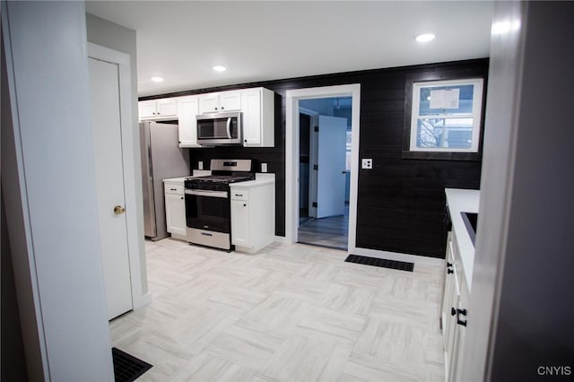 416 Broadway Ave E, Watertown-City, NY 13601 - kitchen with stainless steel appliances, white cabinetry, light countertops, and recessed lighting