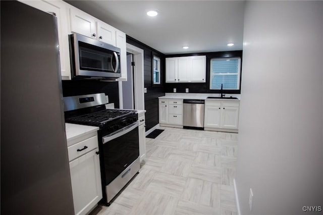 416 Broadway Ave E, Watertown-City, NY 13601 - kitchen featuring stainless steel appliances, a sink, light countertops, white cabinets, and recessed lighting